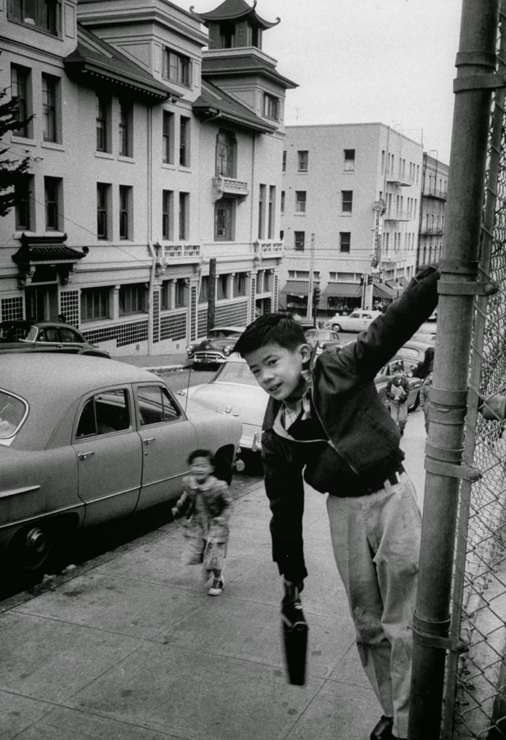 Two children goof around on their way to school.