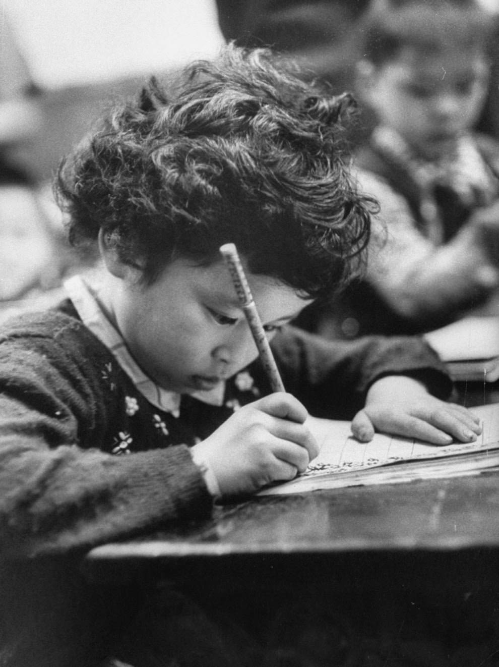 A little girl practices her written Chinese in a character-writing class.