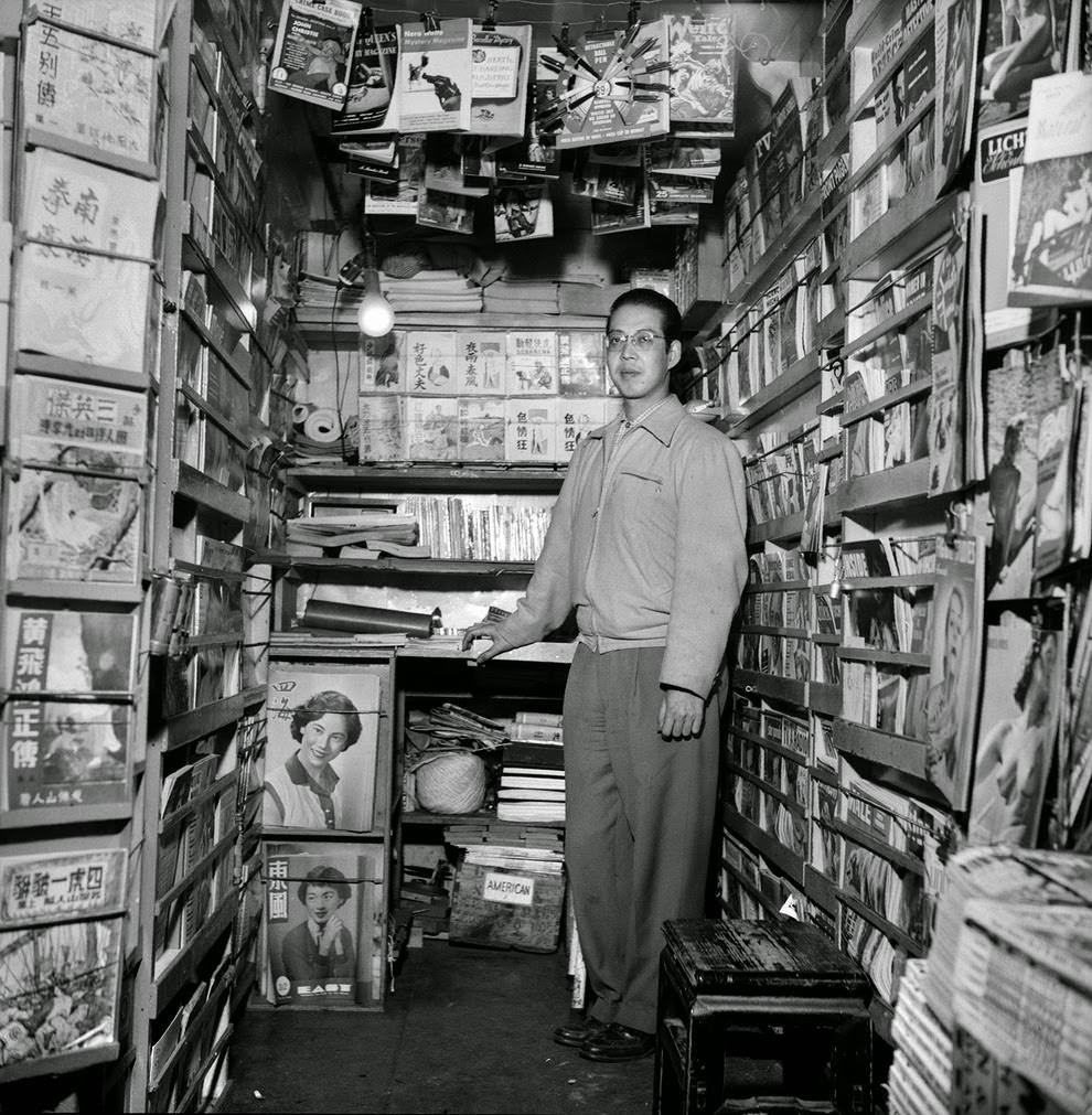 A bookseller waits for customers to arrive.