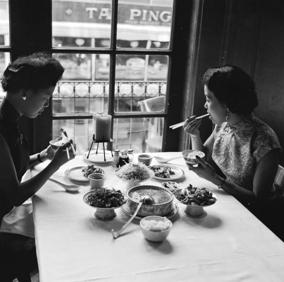 Two women sample food at Johnny Kan’s restaurant.