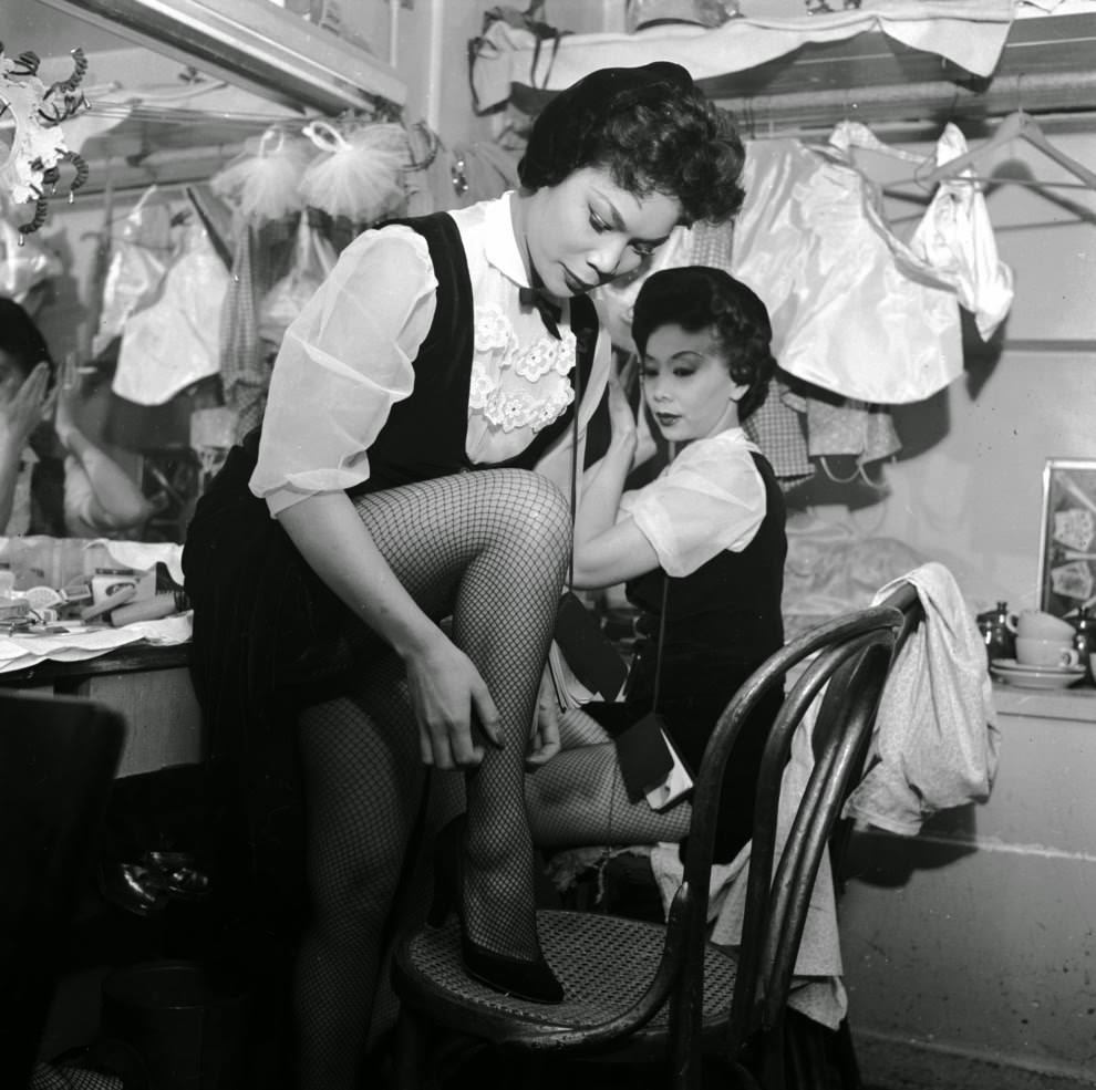 Two chorus girls at the Forbidden City nightclub prepare for their act.