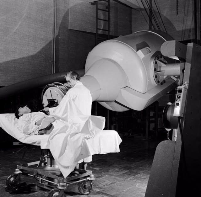A physician adjusts the beam path of the 2,000,000 volt Deep Therapy X-Ray Machine used to treat cancer at the Francis Delafield Hospital in New York City.