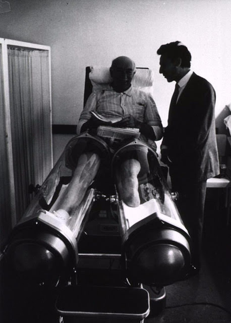 This old man is sitting in a machine that is used to stimulate blood circulation in the legs.
