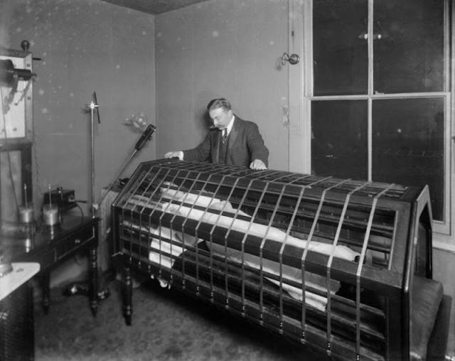 A woman inside an Electric Bath at the Light Care Institute 1900s.