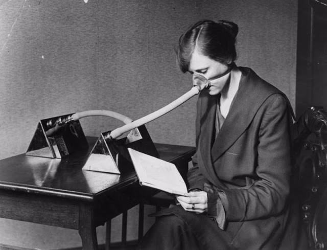 Egy nő influenzamaszkot visel az influenzajárvány során az első világháború után.
