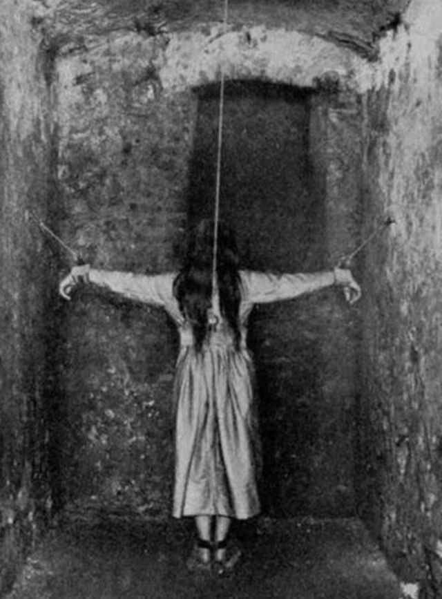 A woman is restrained in an Asylum in France in 1900.