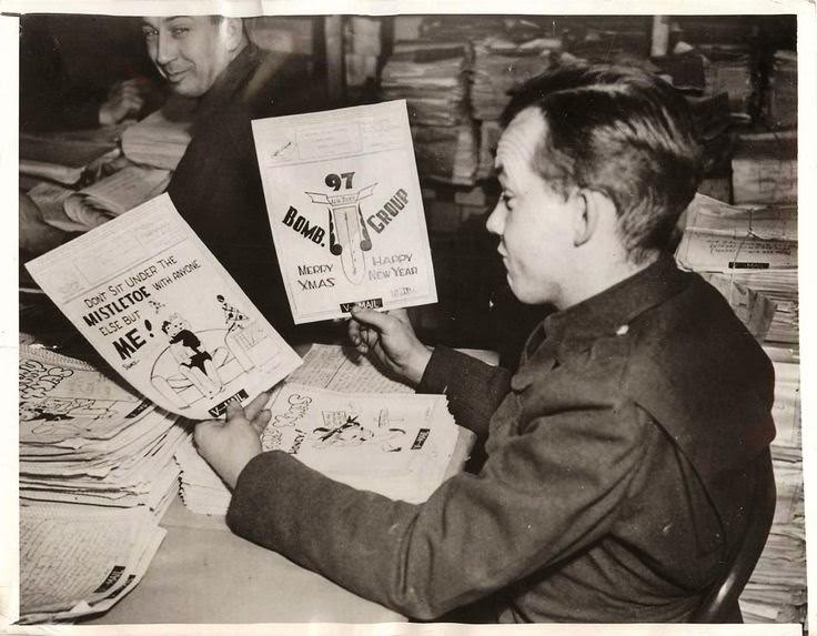 Soldier admires drawings on Christmas V Mail being sent to America from U.S. troops stationed in England, 1942.