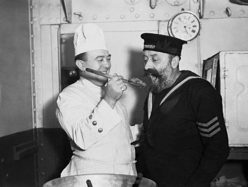 Tasting the Christmas pudding aboard HMS COCHRANE, November 1940.