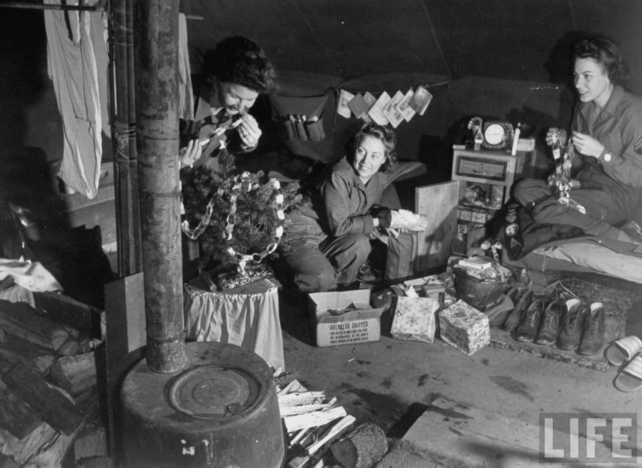 American WACs make paper chains to decorate their tiny tree, Italy, 1944.