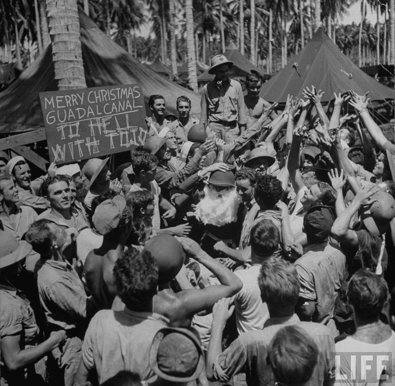 American servicemen (with Santa centre) celebrating Christmas on Guadalcanal, Solomon Islands, 1942.