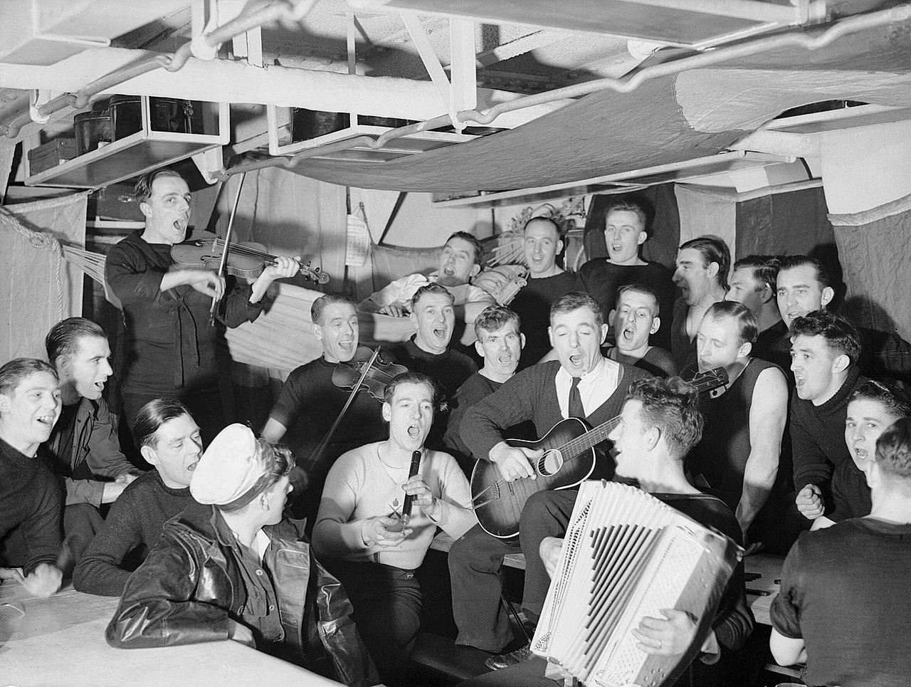 A Christmas singsong on a British warship, 1942.