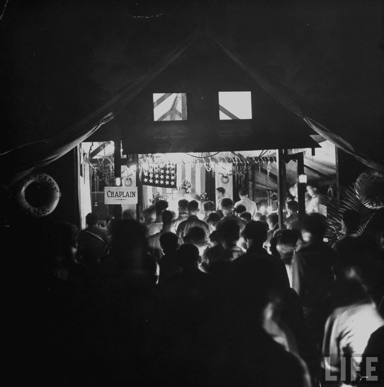 American servicemen at a Christmas midnight mass, Guadalcanal, Solomon Islands, 1942.