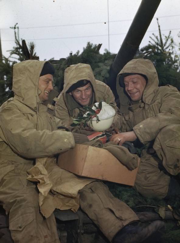 British soldiers unpacking a Christmas parcel, complete with pudding, the Netherlands, 1944.