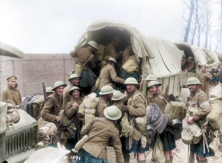 A group of Scottish soldiers wearing kilts smiled for the camera as they prepared to board a truck to head away from the battlefields.