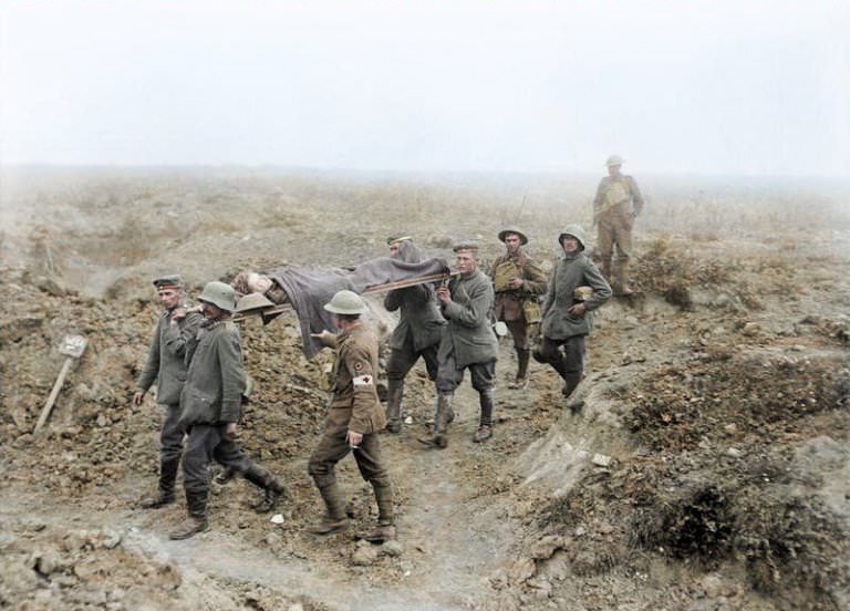 Captain Benjamin H Geary VC, 1st Battalion, East Surrey Regiment being carried in on a stretcher by prisoner bearers at Achiet-le-Petit. 21 Aug 1918.