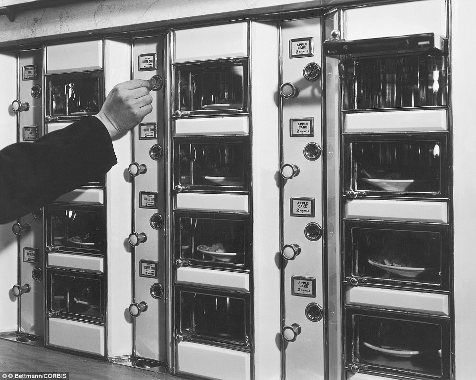 Mid adult couple purchasing ice cream from a vending machine, ca. 1930s.