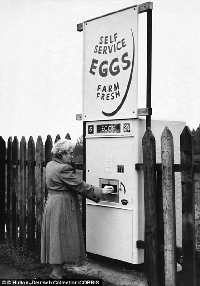 A woman purchases fresh eggs from the machine in Derbyshire, 1963.