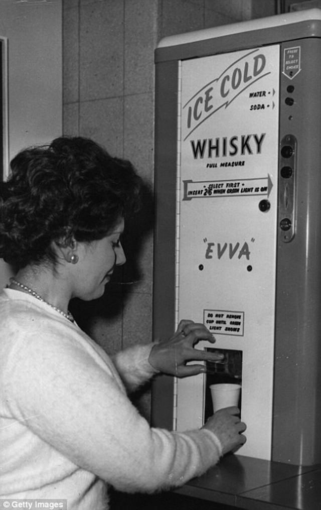 The Sixties saw the rise of self-service booze, a woman buying a whisky, ca. 1960s.