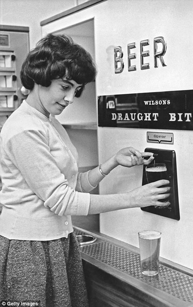 This woman is now able to use a credit card to pay for one of a selection of coffees from this self-serve machine, ca. 1960s.