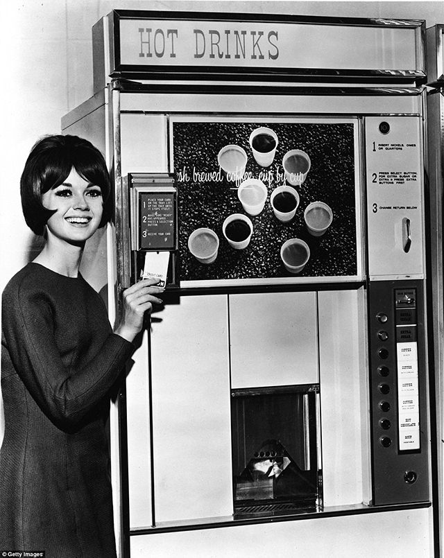 Shoppers could pick up household essentials from this machine. Goods available include Heinz Spaghetti and vegetable soup, Tetley tea, Sugar Puffs, Fray Bentos, Oxo Cubes, soup, light bulbs, mayonnaise and cocoa - all of which could be placed in housewives' own bags, ca. 1960s.