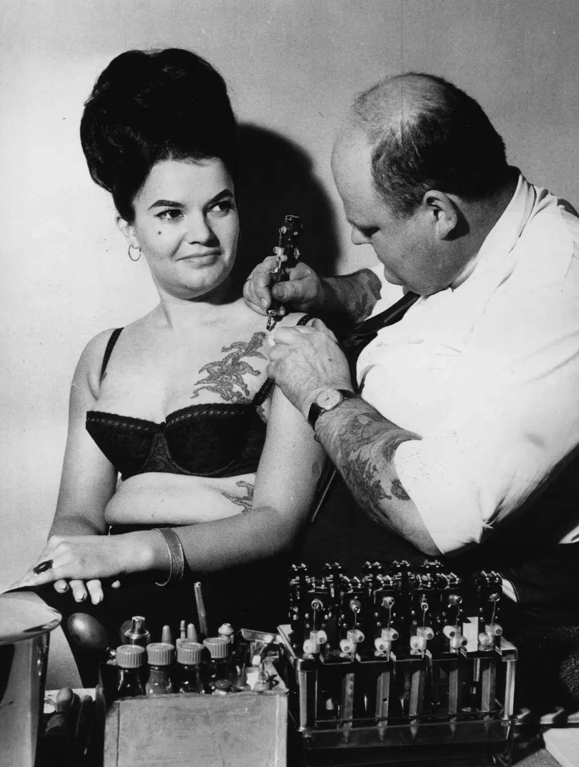 A tattooist works on a chest piece in 1964.