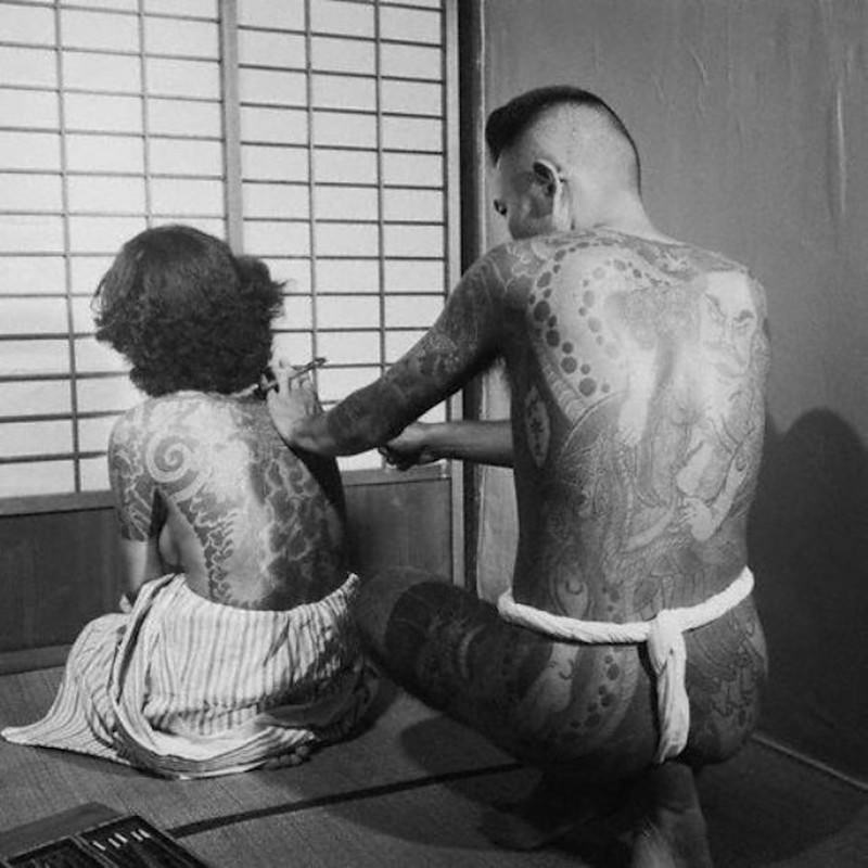 Woman getting a traditional Japanese tattoo.