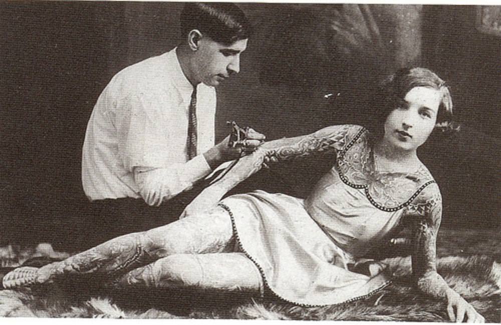 A woman being tattooed, early 1900s