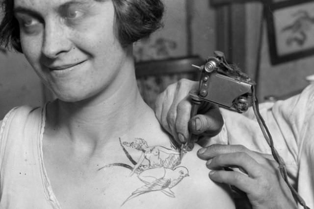 Lady getting a bird tattoo, 1928