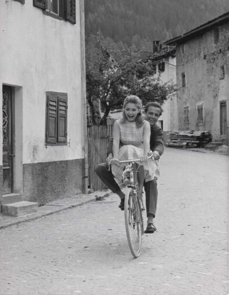 Christine Kaufmann and Joachim Hansen riding a bike.