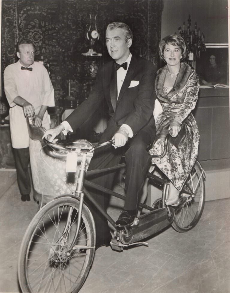 James and Gloria Stewart riding a bike.