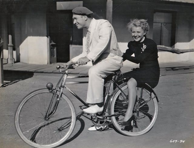 William Newell and Sally Payne riding a bike, 1936