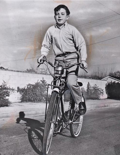 Jerry Mathers riding a bike