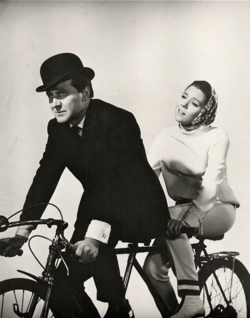 Patrick Macnee and Diana Rigg riding a bike
