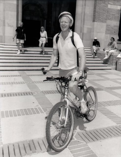 Carole Lombard and Donald Haines riding a bike