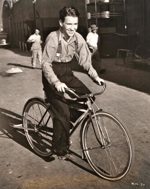 Burgess Meredith riding a bike, 1951