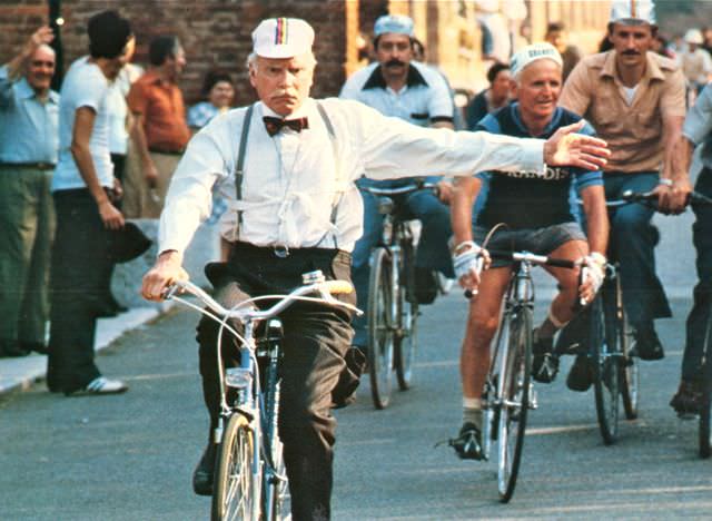 Laurence Olivier riding a bike.