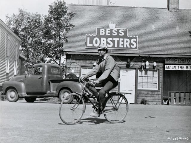 Carl Reiner riding a bike.