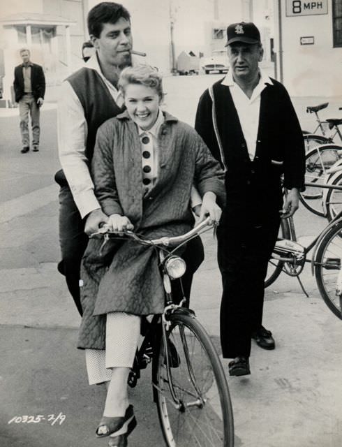 Jerry Lewis and Connie Stevens ride a bike.