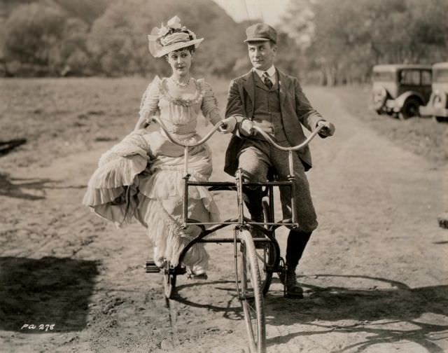 Patsy Ruth Miller and William Demarest ride a side-by-side trike.