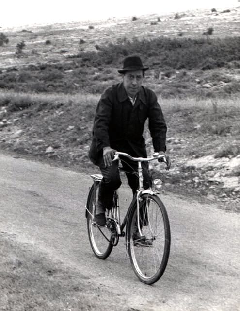 Fernandel riding a bike.