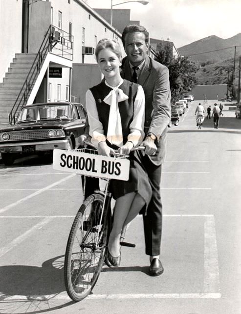 Katherine Crawford and Jason Evers ride a bike.