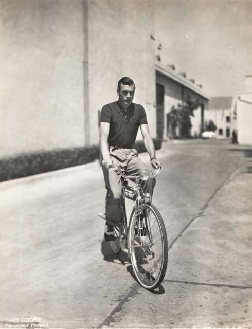 Gary Cooper riding a bike.
