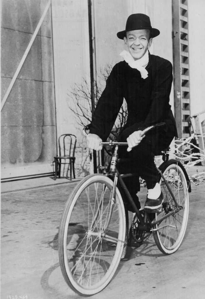 Fred Astaire riding a bike.