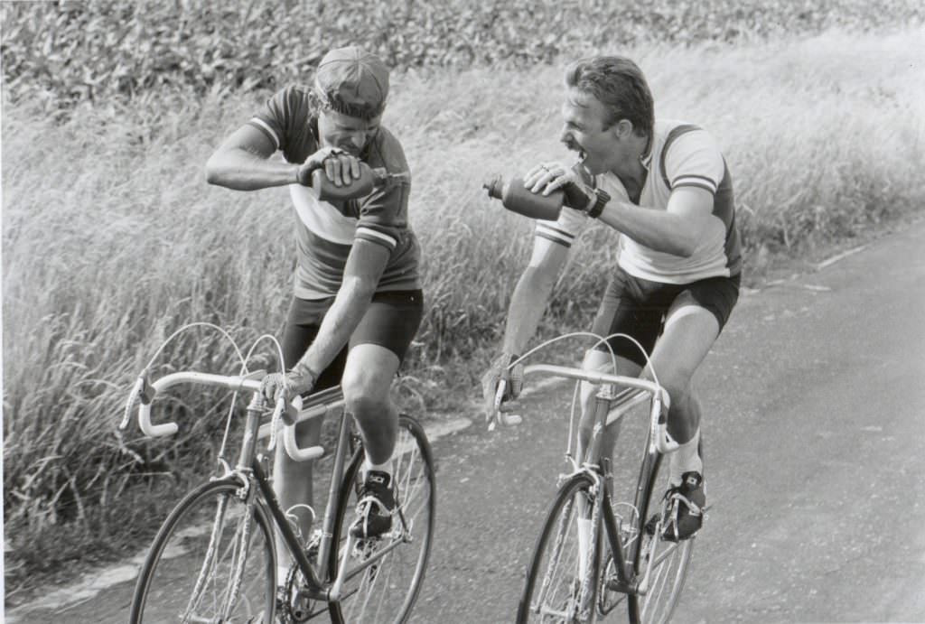David Marshall Grant and Kevin Costner riding bikes.