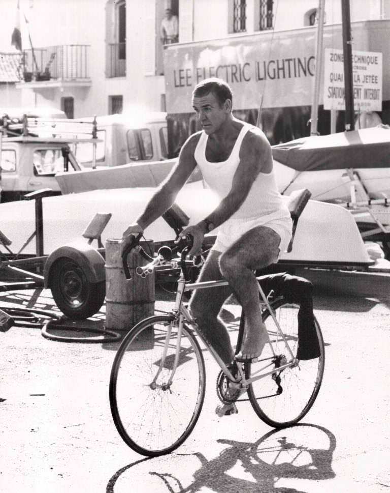 Sean Connery riding a bike.