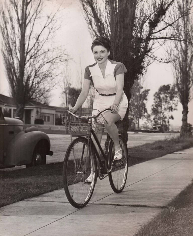 Joan Leslie riding a bike.