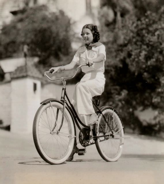 Frances Langford riding a bike.