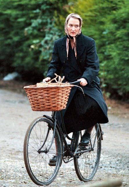 Meryl Streep riding a bike.