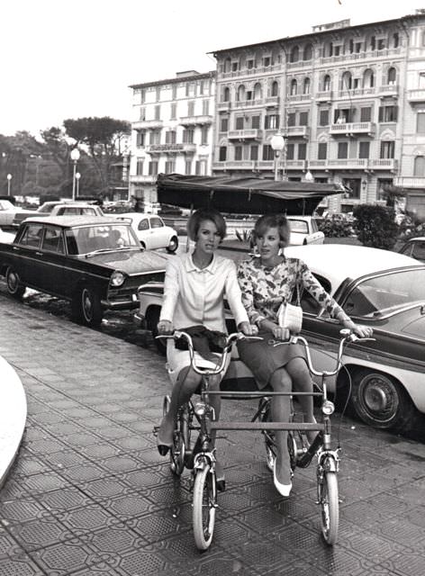 Alice and Ellen Kessler ride a twin bike.