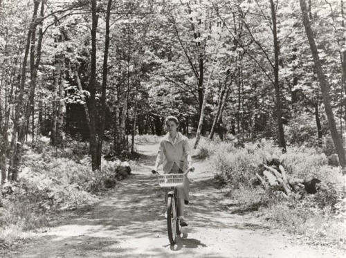 Diane Varsi riding a bike